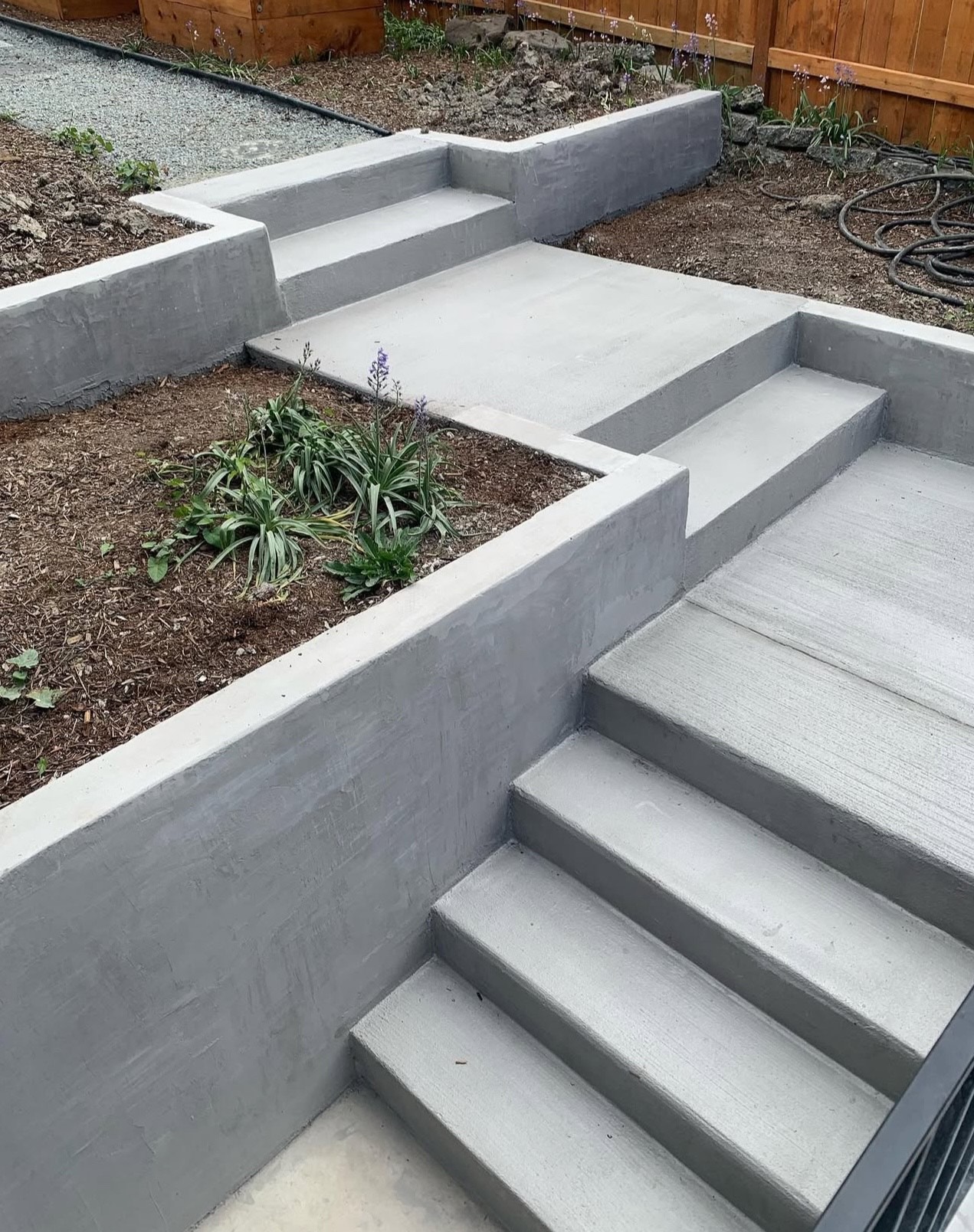 Multi-level concrete stairs with retaining wall planters by Portal in Seattle