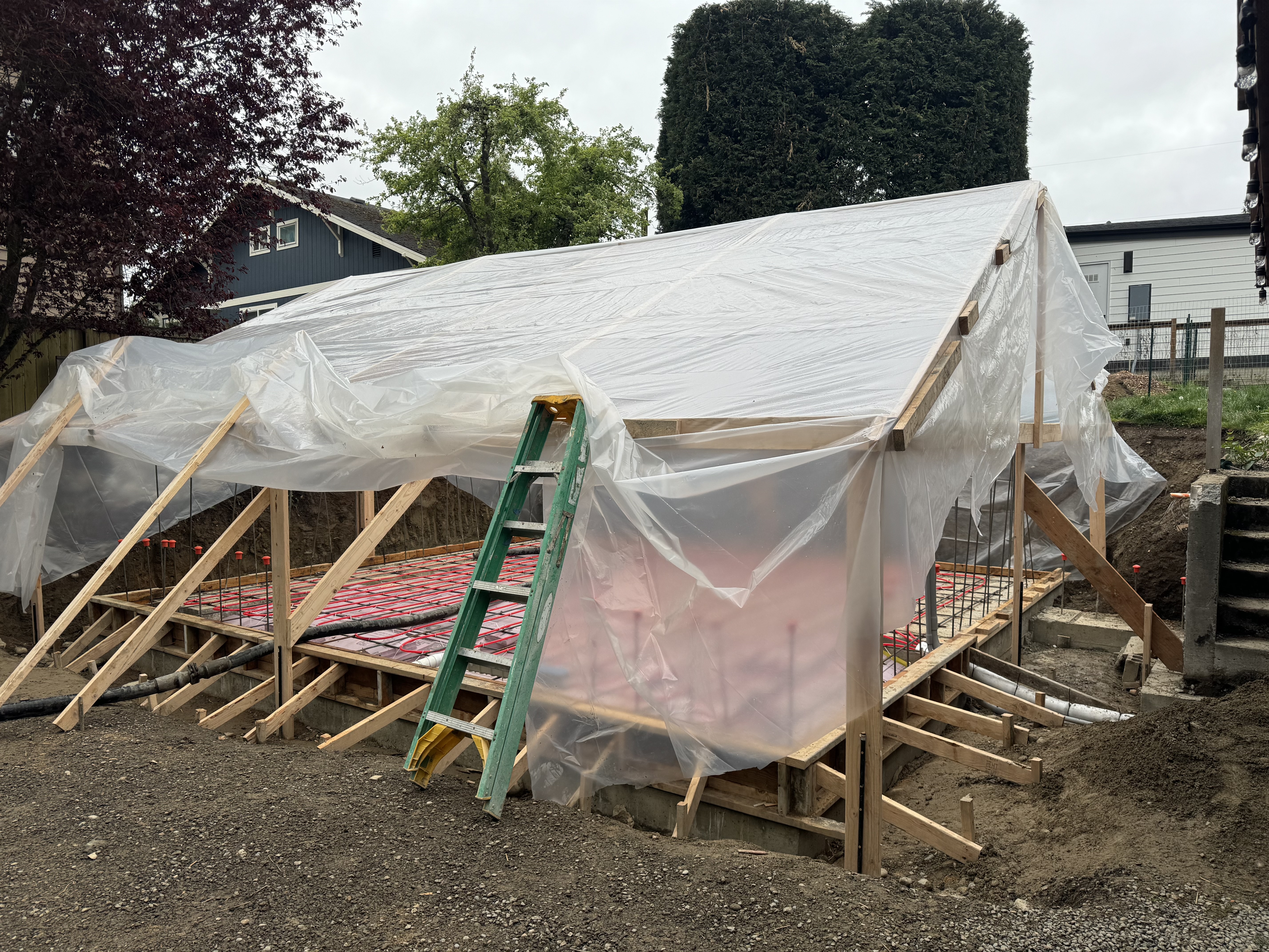 Tent structure protecting a concrete pour from rain